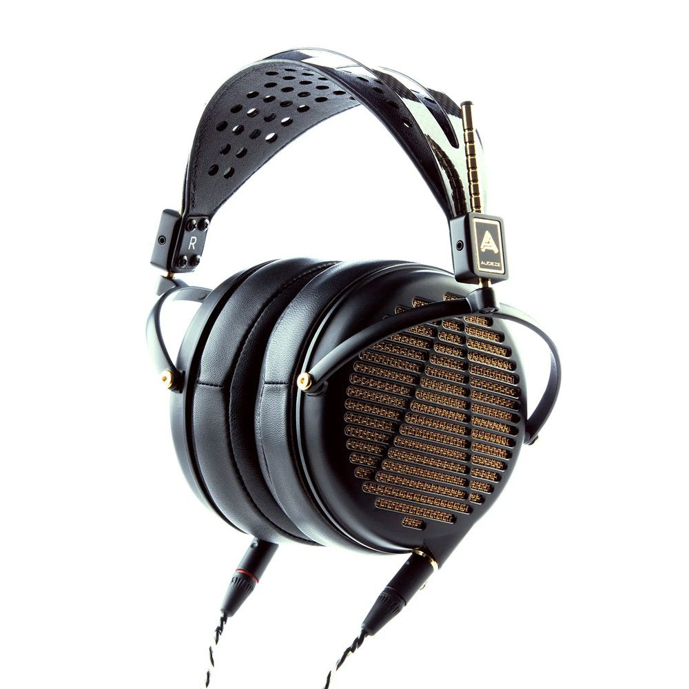 Black over-ear headphones with perforated leather headband and dual cable connectors attached.