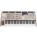 Beige keyboard synthesizer with multiple control knobs, sliders, buttons, and wheels including a wooden side panel and pitch/modulation wheels.