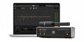 Monitor controller device labeled ARC Studio with a measurement microphone and a laptop displaying software graphs and controls.
