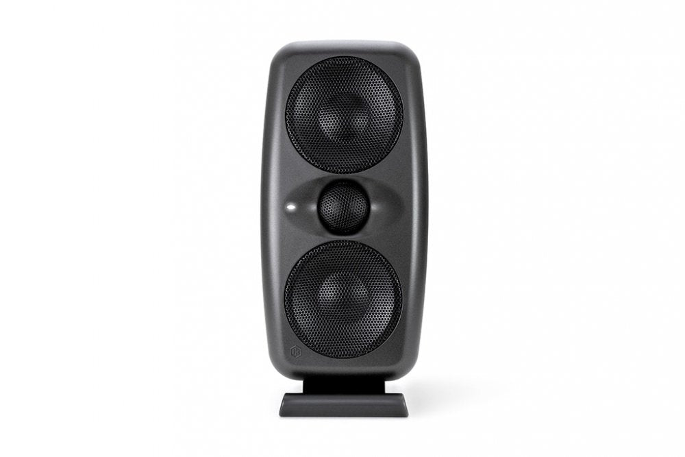 Black studio monitor speaker with two large drivers and one smaller driver in the center on a stand.