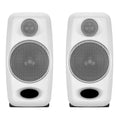 Front view of a pair of white studio monitors with metal speaker grilles and black bass ports.