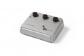 Silver WARM AUDIO CENTAVO device with three black knobs and a foot switch on top.