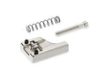 Chrome metal bridge saddle piece with two screws, one coil spring, and one threaded bolt on a white background.