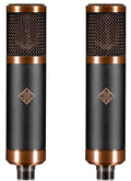 Two black and copper microphones with mesh heads and TELEFUNKEN logos side by side on white background.