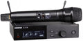 Black wireless handheld microphone resting on a black wireless receiver unit with digital display and control buttons.
