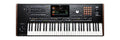 Black electronic keyboard with keys, buttons, pads, sliders, joystick, and a color display screen.