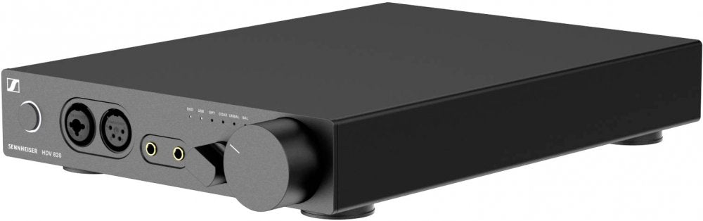 Black rectangular audio device with multiple audio input/output connectors and control knobs on front panel.