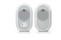 Pair of white JBL speakers with front metal grills and control panel on one speaker