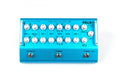 Top view of a blue instrument preamplifier blender with multiple control knobs and three footswitches.
