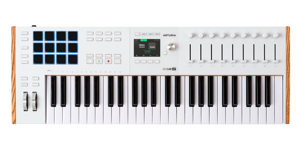 White MIDI keyboard controller with 49 keys, 16 blue pads, 9 faders, 9 knobs, and a small display screen.