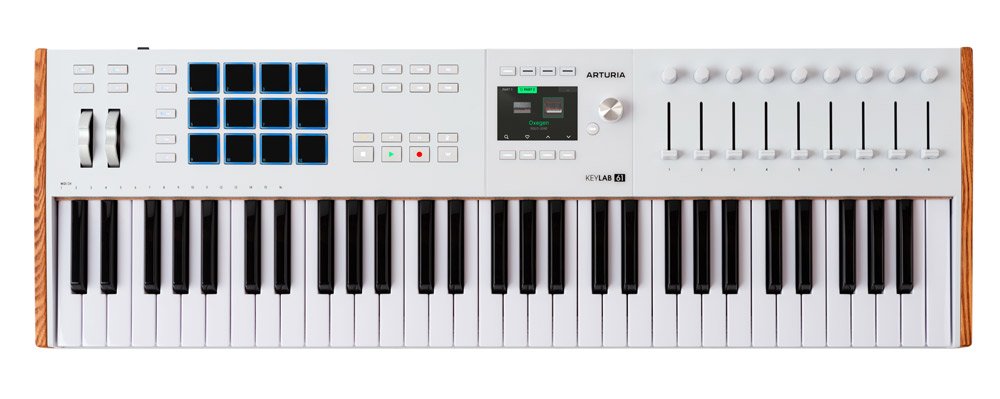 White MIDI keyboard controller with 61 keys, 8 pads, 9 faders, wheels, buttons, and a small display screen.
