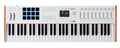 White MIDI keyboard controller with 61 keys, 8 pads, 9 faders, wheels, buttons, and a small display screen.