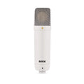 White cylindrical studio microphone with silver mesh grille and RØDE logo on the body.