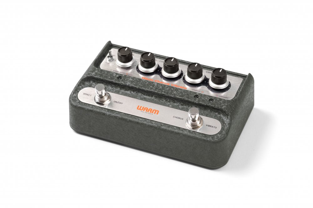 Black and silver modulation pedal with five knobs, two footswitches, and one toggle switch labeled for chorus and vibrato effects.