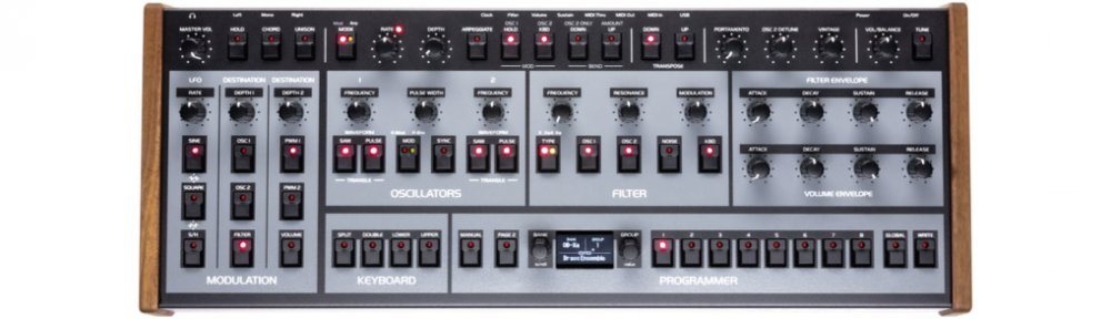 Top view of a synthesizer module with multiple knobs, buttons, and wood side panels.