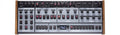 Top view of a synthesizer module with multiple knobs, buttons, and wood side panels.