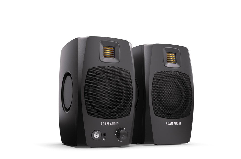 Two black studio monitors with front mesh grilles and headphone jack on one speaker.