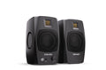 Two black studio monitors with front mesh grilles and headphone jack on one speaker.