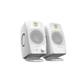 Pair of white studio monitors with metal speaker grilles and controls on the front of one speaker.