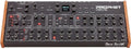 Black analog synthesizer module with multiple knobs, buttons, wood side panels, and digital screen labeled REV2.
