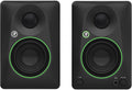 Pair of black studio monitors with green rings around woofers and front controls including tone and volume knobs plus headphone jack.
