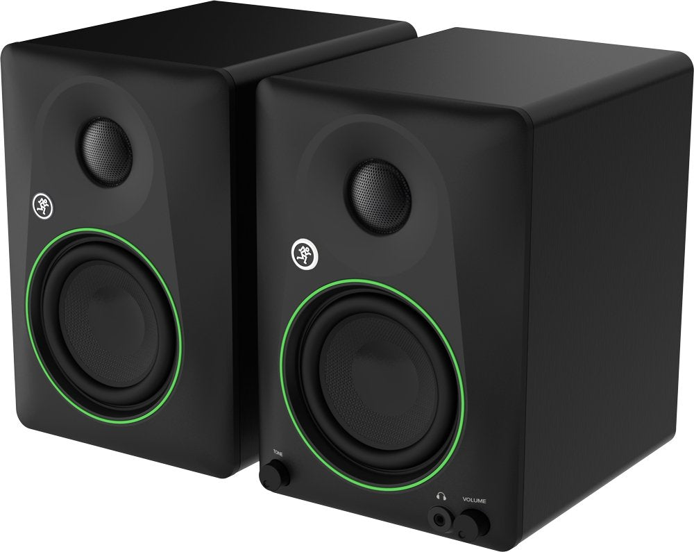 Pair of black studio monitor speakers with green trim, tone and volume knobs, and a headphone jack on the front right speaker.