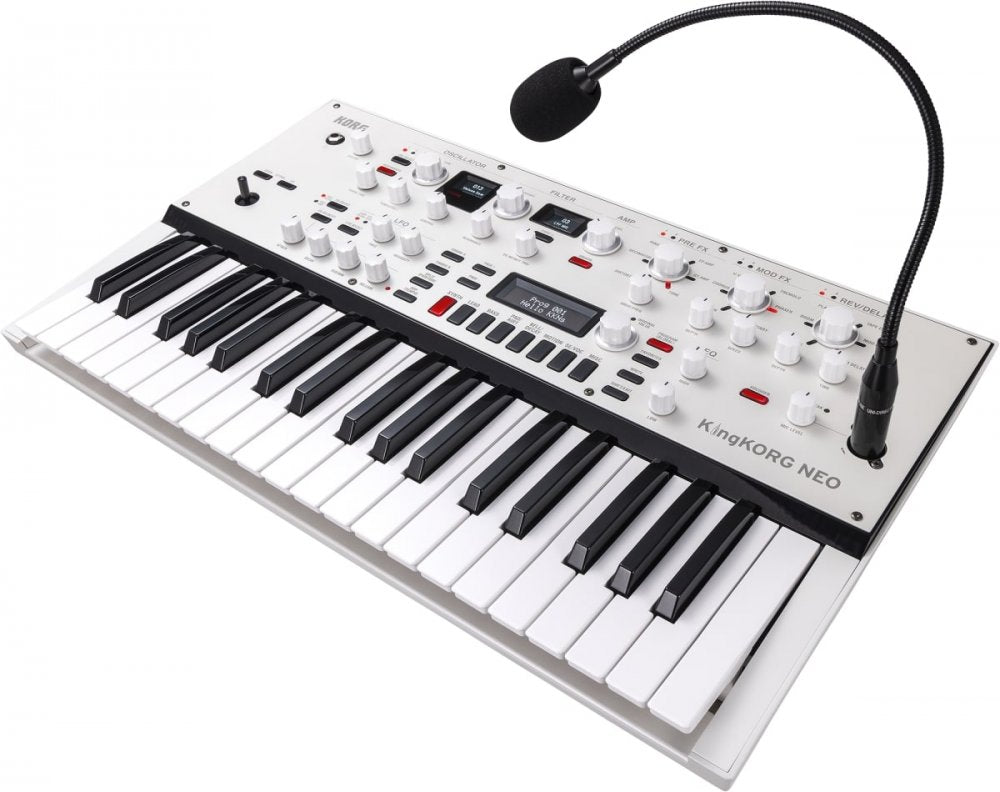 White and black synthesizer keyboard with multiple knobs, buttons, joystick, and a mounted microphone on a flexible arm.
