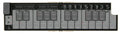 Folded MIDI controller with black keys, sliders labeled PITCH and MOD, and various buttons on a sand beige base.