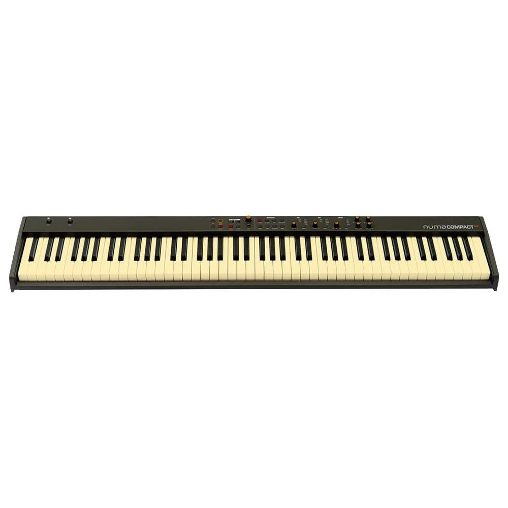 Full-length black and off-white keyboard synthesizer labeled numacompact with control knobs and buttons on top panel.