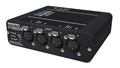 Black audio interface box with four XLR input connectors and status indicator LEDs on the front panel.