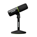 Black SHURE microphone with foam cover mounted on a black stand with green accents.