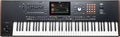 Black keyboard synthesizer with white and black keys, touchscreen, multiple controls, and orange-lit buttons.