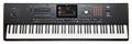 Black KORG Pa5X keyboard synthesizer with multiple keys, sliders, buttons, a joystick, and a color display screen.