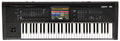 Black synthesizer keyboard with multiple controls, a display screen showing colored interface, and a joystick on the left.