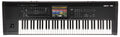 Black synthesizer with multiple keys, faders, buttons, rotary knobs, joystick, and a colored touchscreen display in the center.
