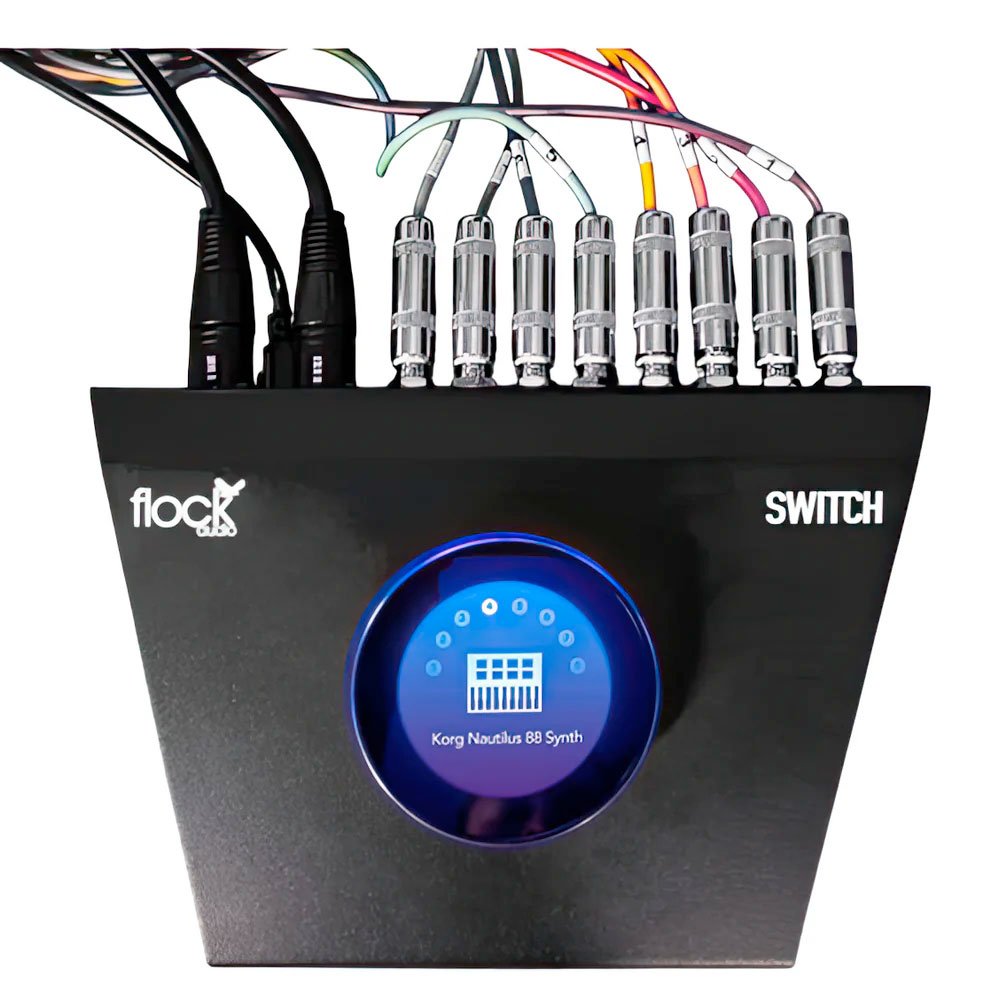 Black patchbay device with multiple cables connected and a blue circular display labeled 'Korg Nautilus 88 Synth'