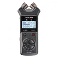 Handheld audio recording device with dual microphones, display screen, and control buttons including record and stop.