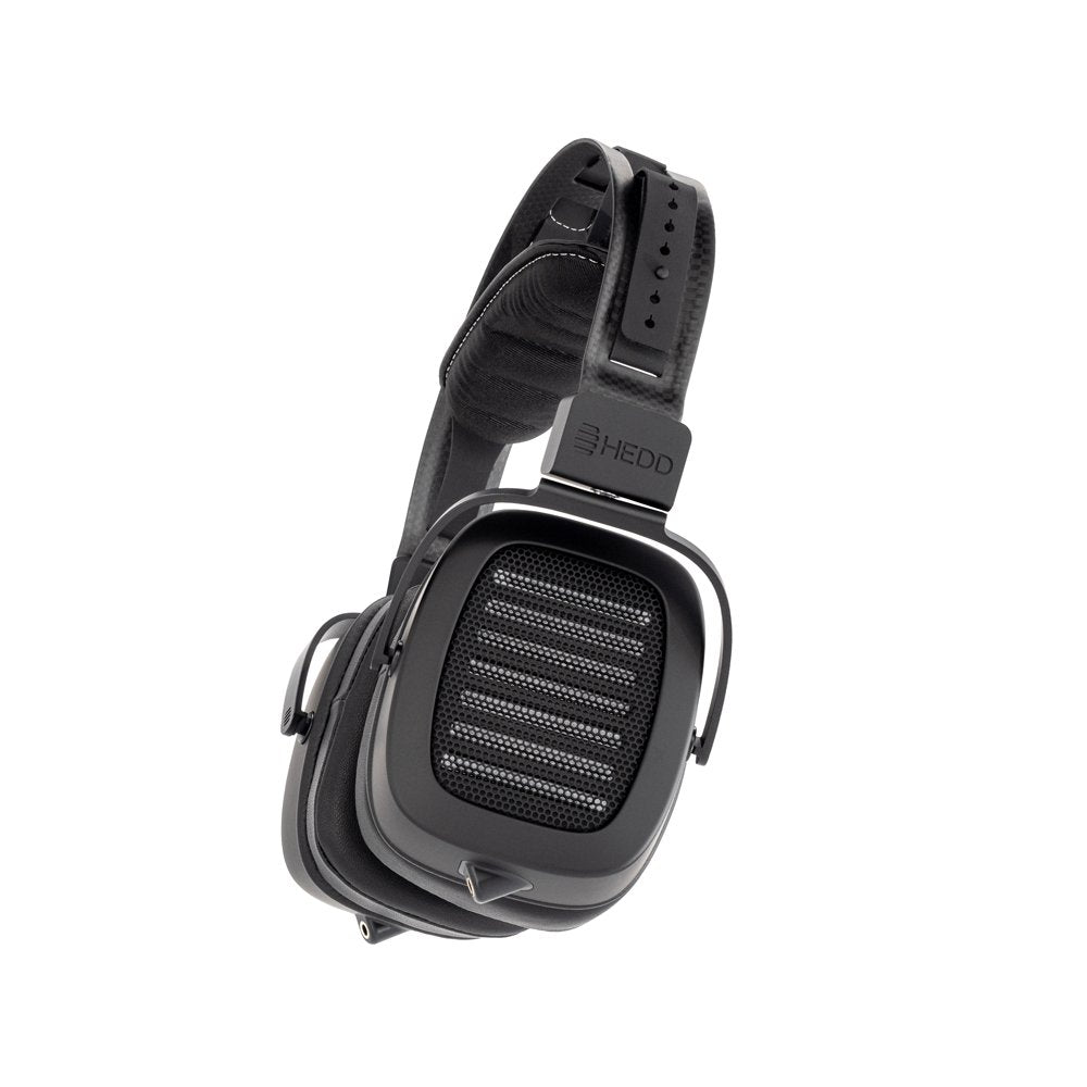 Black over-ear headphones with rectangular ear cups and visible audio jack socket on the left ear cup.