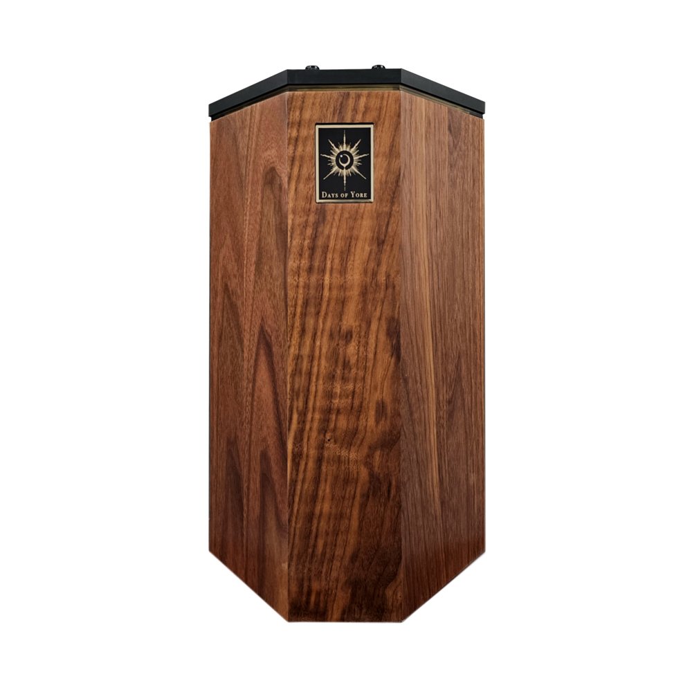 Hexagonal wooden box with a black top and a gold Days of Yore logo plaque on the front.