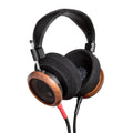 Black and brown over-ear headphones with foam ear pads and dual cables, showing the Grado branding.