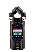 Black Zoom H5studio audio recorder with dual microphone capsules, screen, knobs, and buttons.