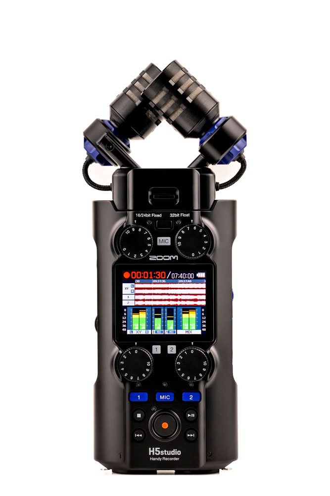 Black Zoom H5studio audio recorder with dual microphone capsules, screen, knobs, and buttons.