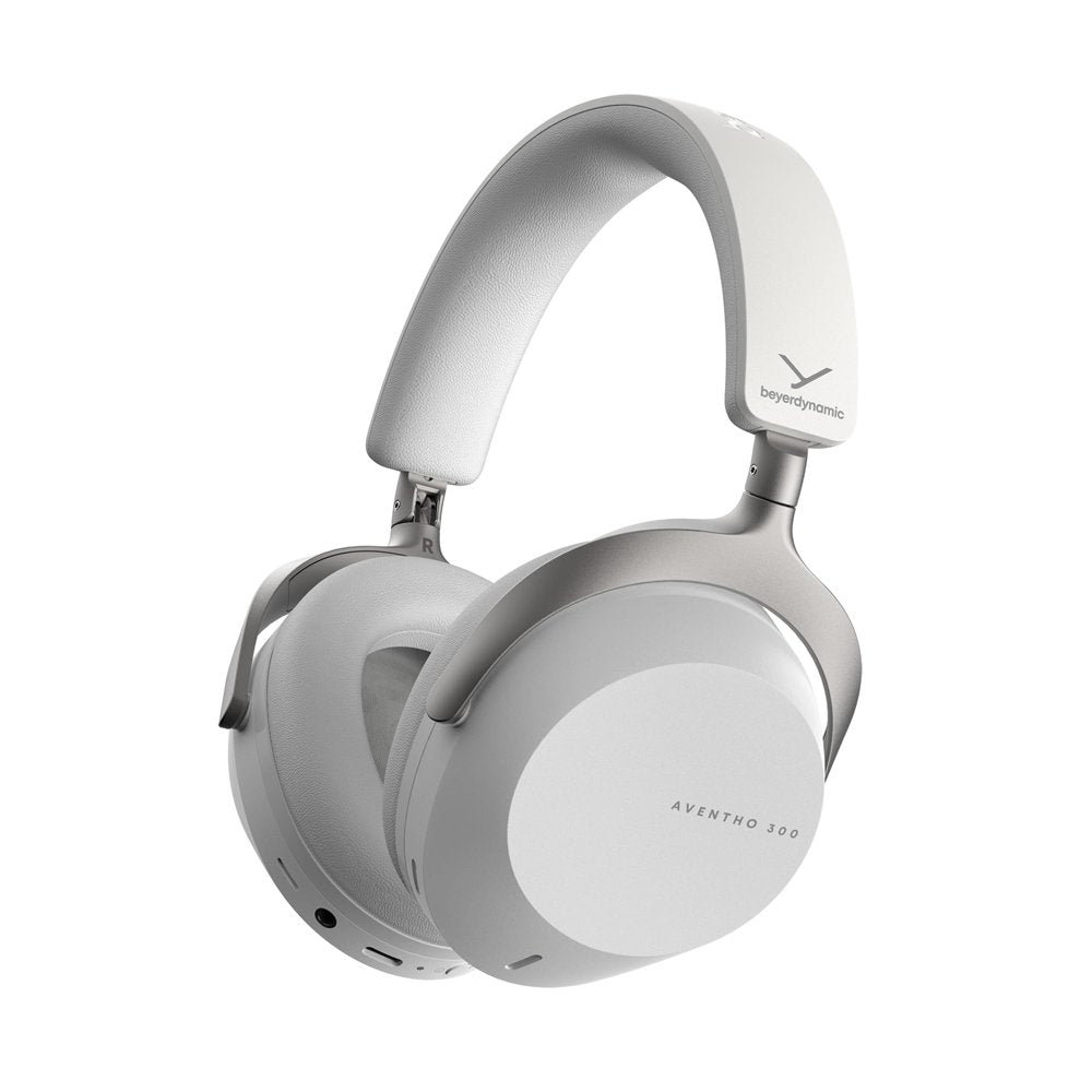 White and grey over-ear headphones with padded headband and ear cups, showing buttons and ports on the ear cup edge.