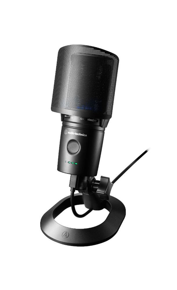Black Audio-Technica microphone mounted on a stand with a pop filter and connected via USB cable.