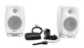 Two white Genelec studio monitors with accompanying black control pod and cables shown on a white background.