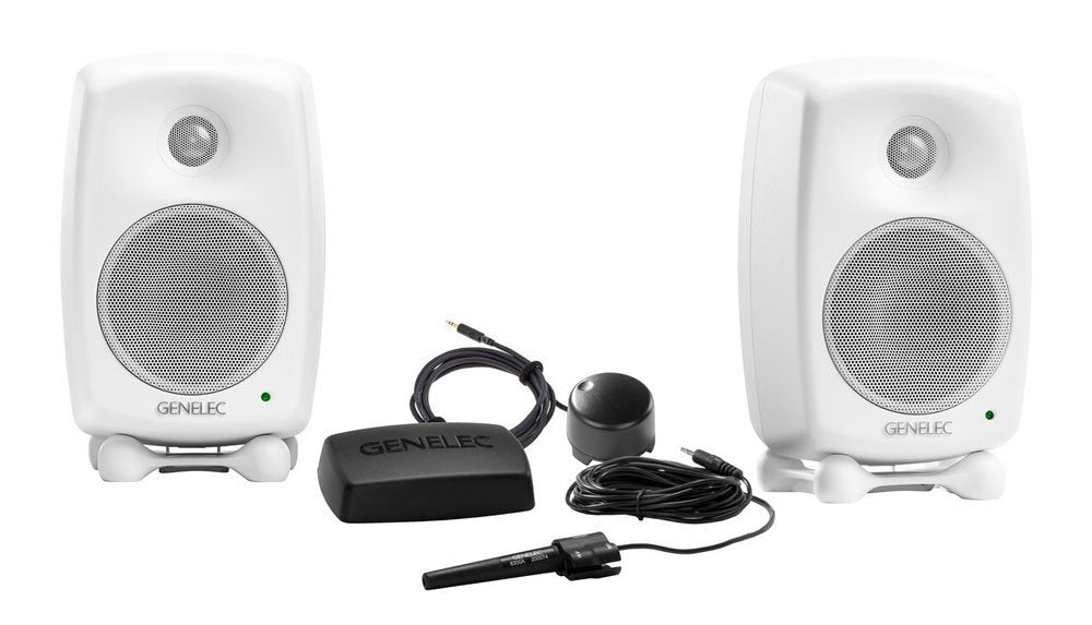 Two white Genelec studio monitors with accompanying black control pod and cables shown on a white background.