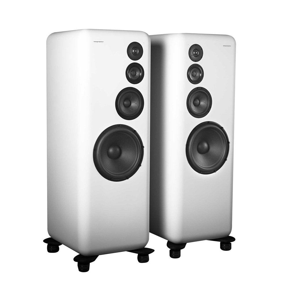 Pair of white floor-standing studio monitor speakers with four black speaker drivers each.