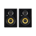 Pair of black studio monitors with yellow speaker cones and KRK Systems logo on front.