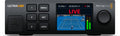 Front view of a Blackmagic Design video streaming device with buttons, USB port, screen showing live tennis match, and rotary knob.