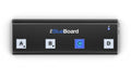 Black rectangular device with four square buttons labeled A, B, C, D and a blue LED near the top right.